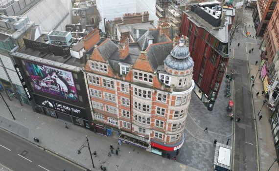 Drone capturing high-resolution imagery of building façade on Oxford Street in busy West End