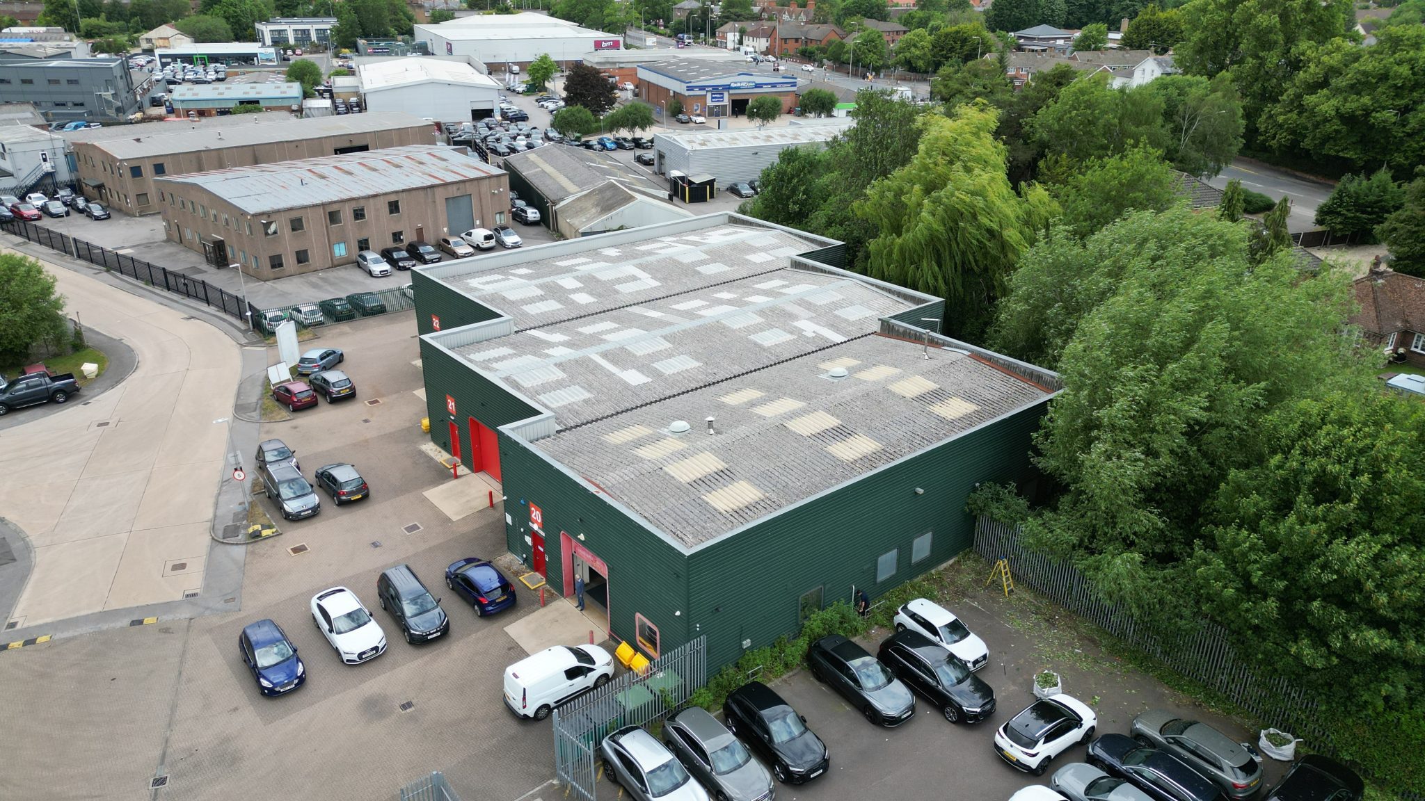 High-level drone view of industrial estate showing roofs and yard areas