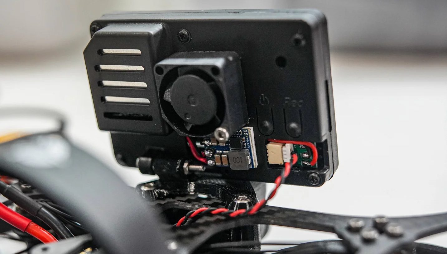 Naked GoPro mounted on lightweight FPV drone for high-quality footage with reduced payload weight.
