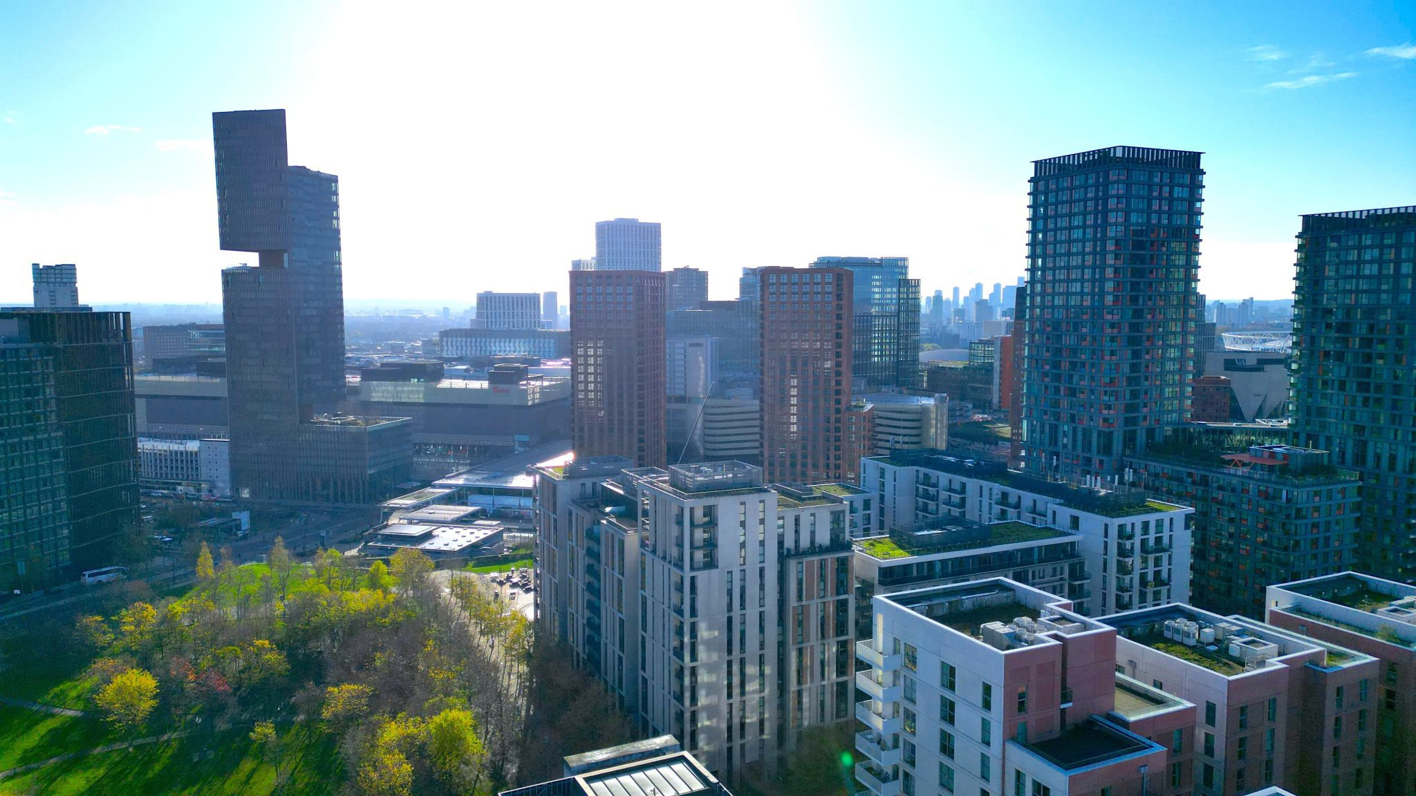 Aerial view of East Village with Stratford International and surrounding towers under a clear London skyline.