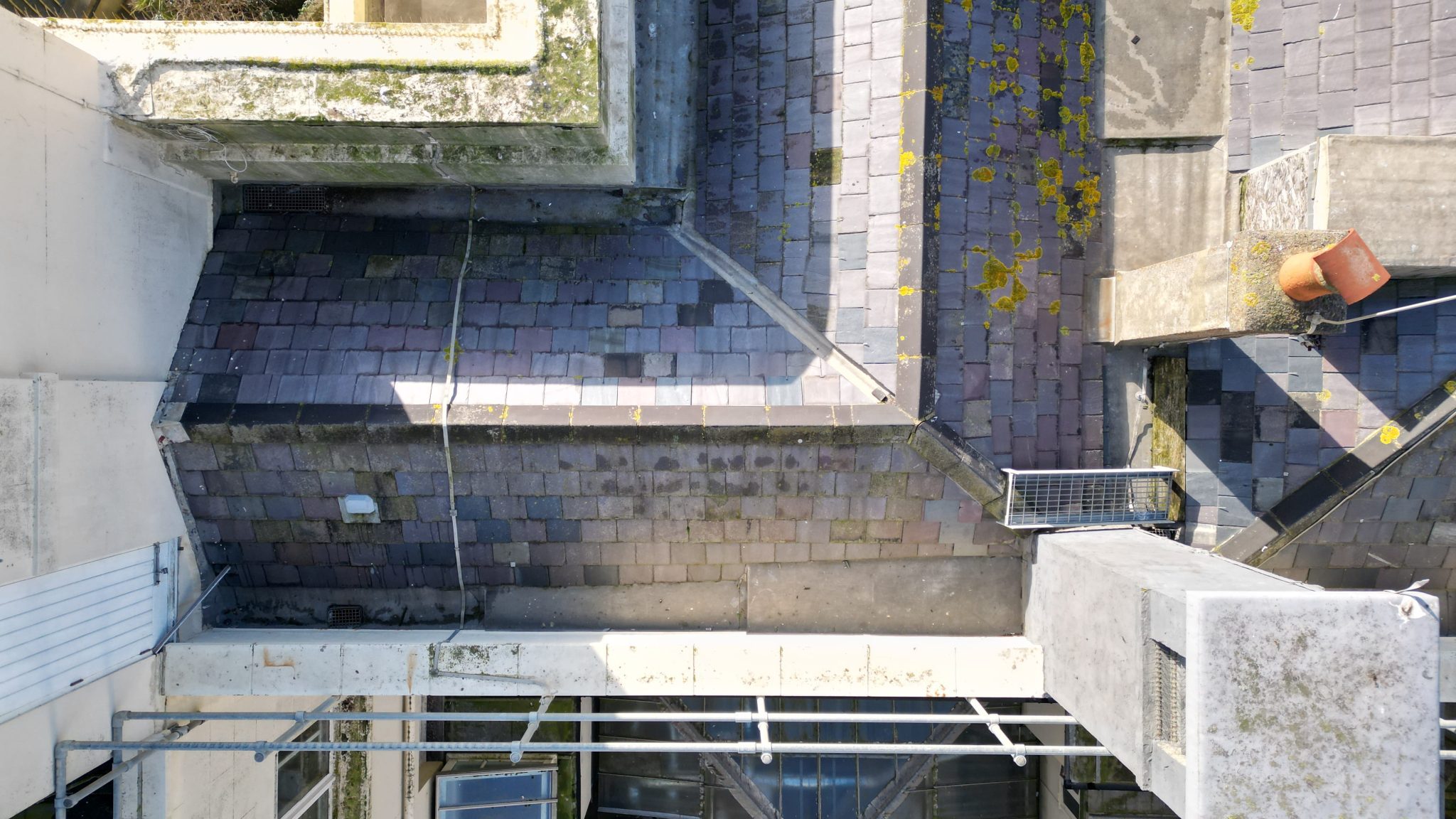 Close-up UAV image of Brighton Town Hall roof, showing pitched roof, rainwater goods, and chimney details for condition inspection.