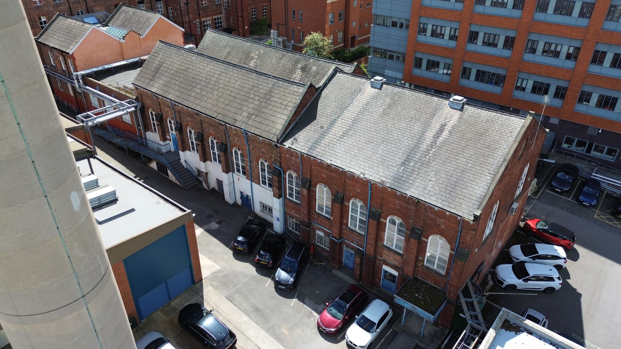 Drone overview of a heritage hospital building at St James's University Hospital, supporting a structured inspection of historic timber windows and façades.