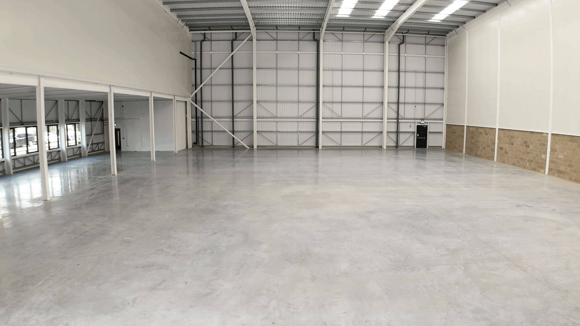 High-resolution drone image of a completed industrial unit at Forest Road Estate, showcasing the finished development and internal warehouse areas.