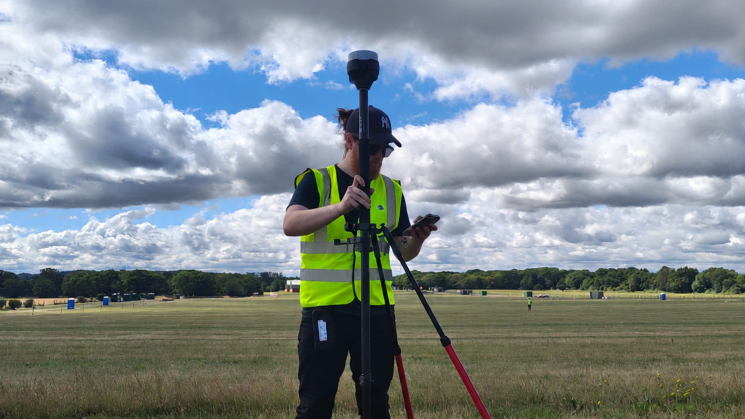 Survey operative using a GNSS receiver in the field to support UAV survey positioning.