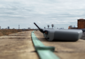 featured_image UAV controller positioned on the Royal Albert Hall roof during an inspection survey, with lightning conductor tape and the London skyline visible in the background.